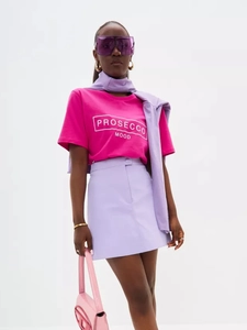 Detail of rose red cotton t-shirt with PROSECCO MOOD print and purple skirt outfit