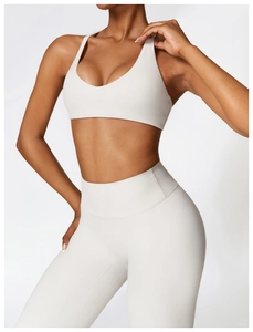 Detail of high-waist yoga pants in cream white featuring matte texture and seamless design