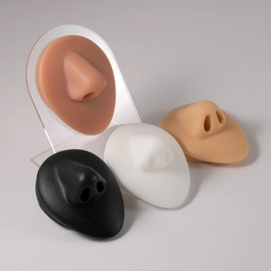 Detailed side view of silicone nose models for piercing display on acrylic stands