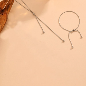 Detailed view of adjustable silver snake chain necklace and bracelet set with metal beads