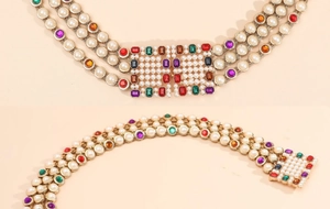 Detailed macro of gold metal chain with multi-colored rhinestones and pearls belt