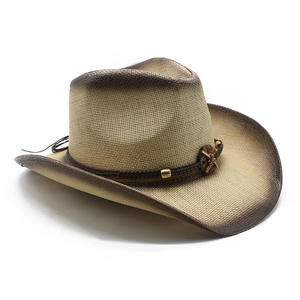 Detail of hand-woven cowboy hat featuring a vintage cross emblem and rustic beaded band