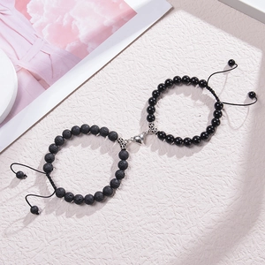Close-up of heart magnet couple bracelets with matte lava and obsidian beads