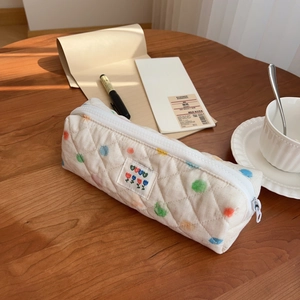 Quilted cotton pencil case with colorful polka dots and BEST floral patch on desk