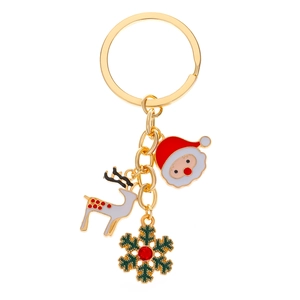 Close-up of golden Christmas keychain with Santa, reindeer and snowflake pendants
