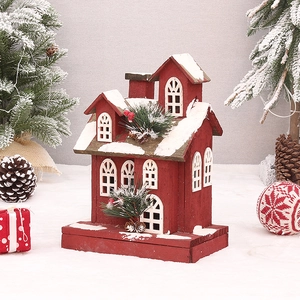 Rotes Weihnachtshaus aus Holz mit Kunstschnee, Tannennadeln und festlichen Beeren