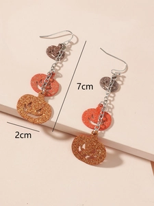 Macro view of sparkly triple-tiered pumpkin earrings with 7cm length measurements