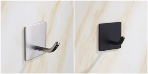 Detail showing brushed silver and matte black stainless steel hooks on marble wall