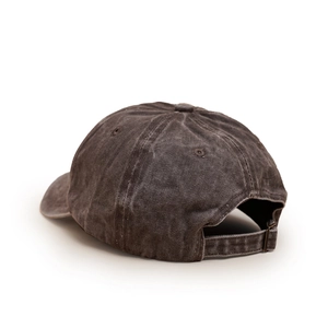 Close-up of washed cotton baseball cap featuring vintage texture and adjustable metal buckle