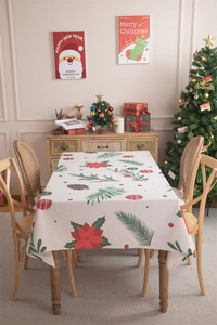 Detailed view of Christmas tablecloth with poinsettia, pine cones and festive print