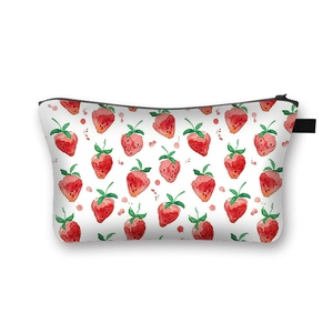 Portable white cosmetic bag with red strawberry prints and black zipper closure