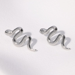 Polished silver stainless steel snake stud earrings in a minimalist 3D curved design