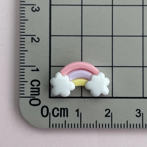Macro size reference for rainbow cloud resin charms showing dimensions on a centimeter scale