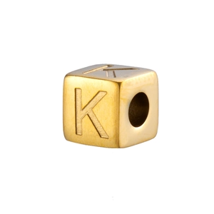 Macro shot of 14K gold plated stainless steel cube bead featuring engraved letter K