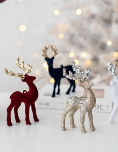 Detail of glitter and flocked Christmas reindeer ornaments with hanging strings