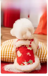 Detail of red festive pet Tang suit with white faux fur trim and embroidery for dogs