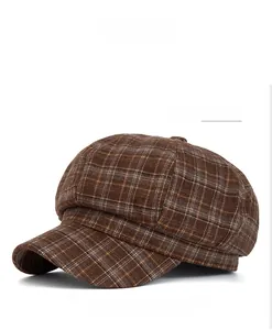Close-up of retro plaid pattern texture on a coffee brown newsboy octagonal cap