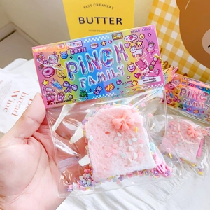 Squishy pink toast stress relief toy with bow and colorful sprinkles in hand