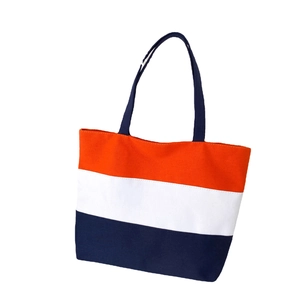 Three-color striped canvas tote bag in orange, white, and navy blue with shoulder straps