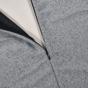 Detail of grey textured fabric with hidden black zipper and soft cream lining