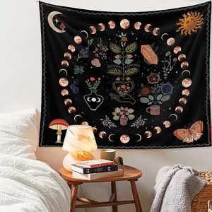 Bohemian black mandala tapestry hung over a bed headboard creating a cozy bedroom decor