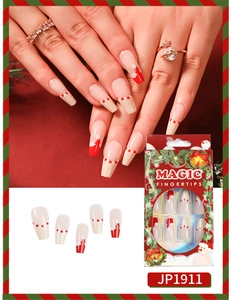 Macro detail of Christmas press-on nails featuring red Santa hat patterns and 24pc set