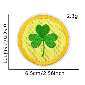 Close-up of a green shamrock embroidered patch with size 6.5cm and weight 2.3g markings