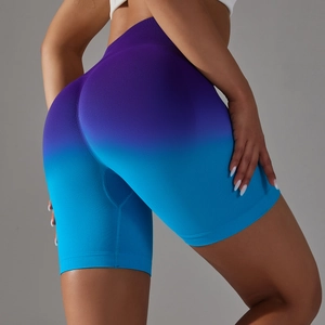 Detail of high-waisted seamless fitness shorts with blue-purple gradient and peach lift
