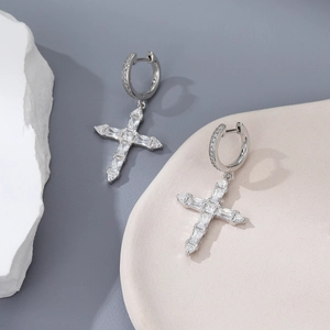 Detail view of 925 sterling silver hoop earrings with sparkling cross zircon pendants