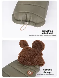 Detail of olive pet puffer coat showing bear ear hood and heart-shaped leather patch