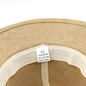 Detail of inner paper straw hat showing size 57 label and 100% paper material tag