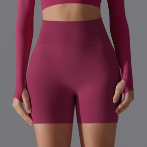 Detail of high waisted seamless yoga shorts with ribbed waistband in deep magenta pink