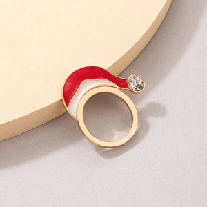 Detailed view of enamel Christmas hat ring with gold plating and sparkling rhinestone