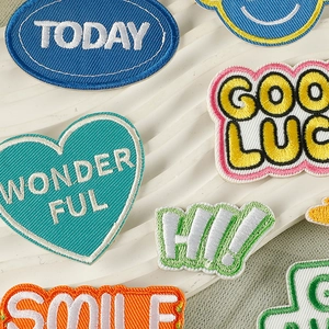 Colorful embroidered patches with English slogans like Wonderful and Good Luck for DIY crafts