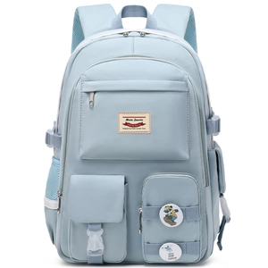 Detailed view of light blue nylon backpack with functional pockets and buckle straps