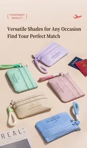 Five macaron-colored travel organizers with zippers and soft wrist straps on a desk