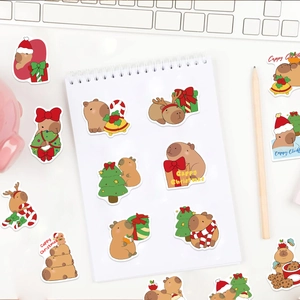 Close-up of Christmas capybara stickers on desk with Cappy Christmas text