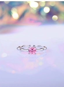 Detailed view of square pink gemstone ring with silver bamboo textured adjustable band
