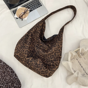 Detailed view of leopard print suede tote bag with large capacity in lifestyle setting