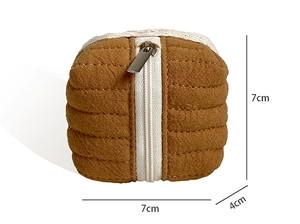 Detail shot of a square quilted storage bag measuring 7cm x 7cm x 4cm with white zipper