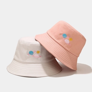 Spring cotton bucket hats in beige and pink featuring creative planet embroidery designs