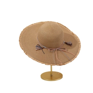 Women's wide brim straw sun hat with fringe edges and colorful tassel cord for beach vacation