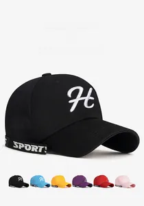 Detail of embroidered H logo and ribbon with various color swatches for baseball caps