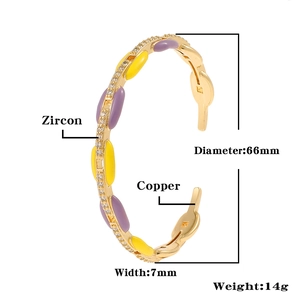 Detail view of gold-plated copper bangle with zircons, enamel inlays, 66mm diameter