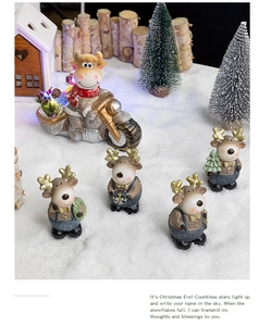 Macro detail of resin Christmas deer and bull motorcycle ornaments in a snowy festive scene