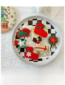 Detailed close-up of handmade crochet Christmas hair clips with festive reindeer and sock shapes