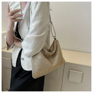 Detail of champagne gold rhinestone mesh shoulder bag with sparkling metallic texture