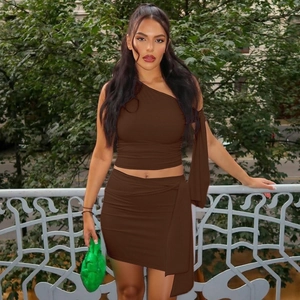 Detail of dark brown asymmetric one-shoulder top and matching slim-fit wrap skirt outfit