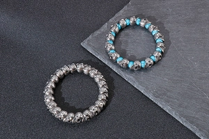 Detail of punk skull bracelets in vintage silver steel and blue turquoise beads