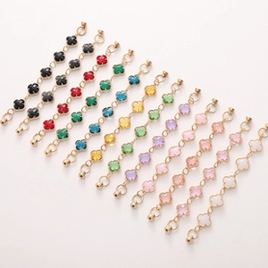 Detailed view of colorful four-leaf clover charms on gold-finished extender chains